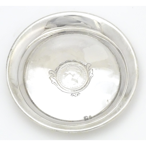 453 - A Portuguese silver dish with inset coin decoration dated 1909. Approx. 4