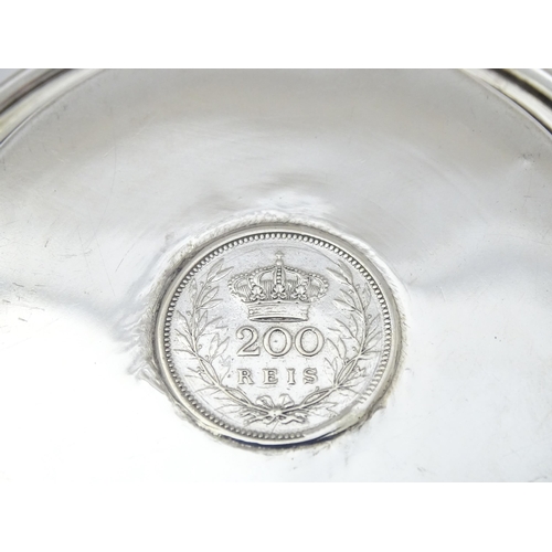 453 - A Portuguese silver dish with inset coin decoration dated 1909. Approx. 4