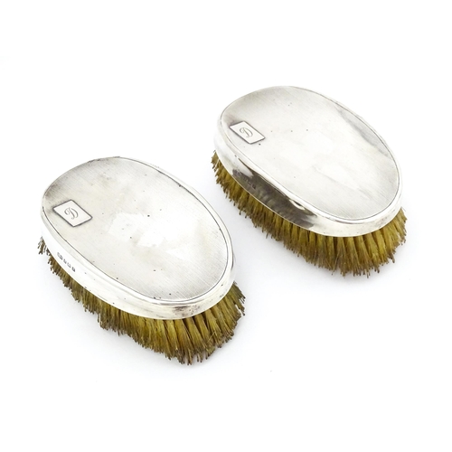 497 - A pair of Art Deco silver backed hair brushes of oval form with engine turned decoration, hallmarked... 