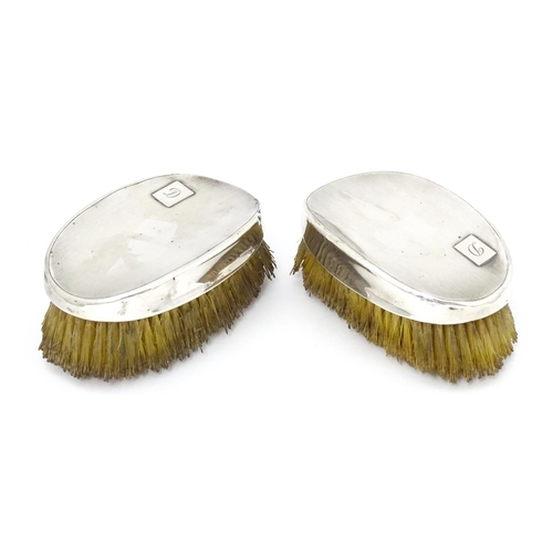 497 - A pair of Art Deco silver backed hair brushes of oval form with engine turned decoration, hallmarked... 