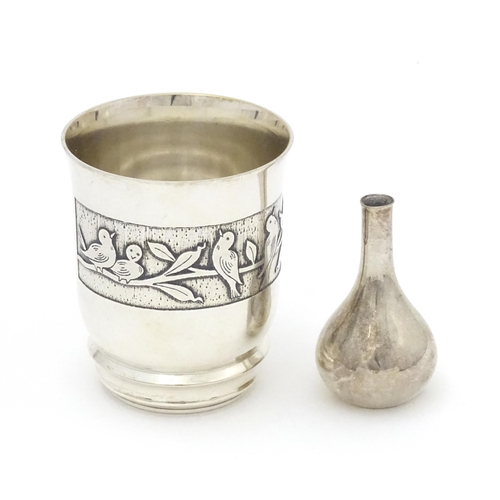 500 - A Continental silver plate beaker with bird decoration. Together with a Danish small taper stick hol... 