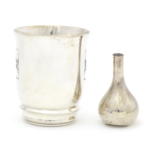 500 - A Continental silver plate beaker with bird decoration. Together with a Danish small taper stick hol... 