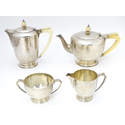 518 - An Art Deco silver four piece tea set hallmarked London 1934/35 with jubilee mark, maker Edward Barn... 