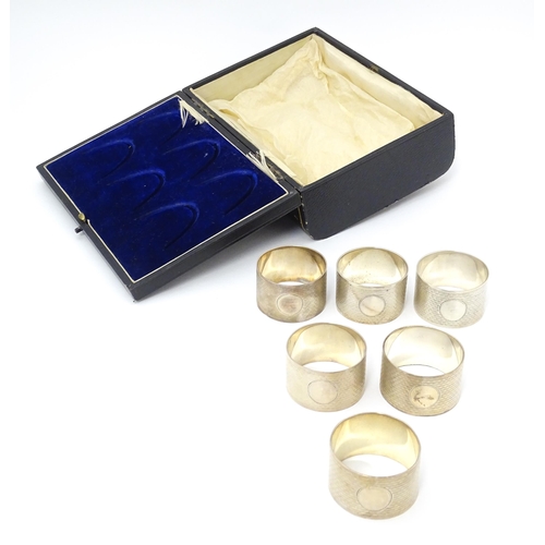 531 - A cased set of six silver napkin rings with engine turned decoration hallmarked Birmingham 1912, mak... 