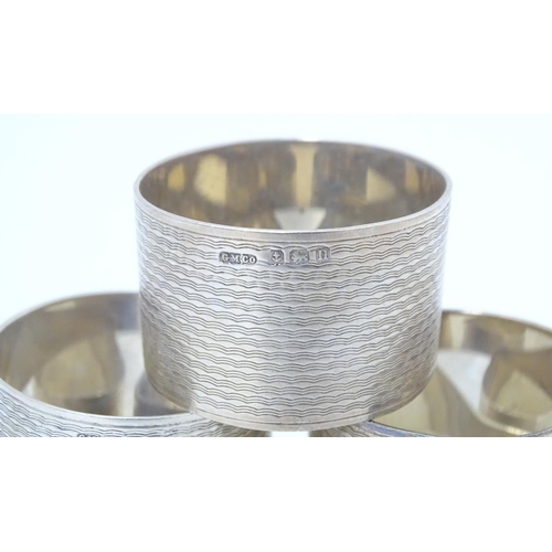 531 - A cased set of six silver napkin rings with engine turned decoration hallmarked Birmingham 1912, mak... 