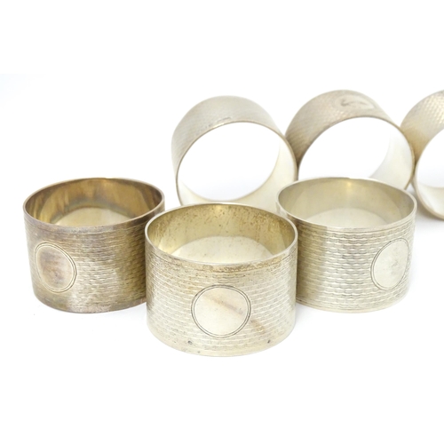 531 - A cased set of six silver napkin rings with engine turned decoration hallmarked Birmingham 1912, mak... 