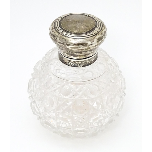 534 - A cut glass dressing table jar with silver lid and mount hallmarked Birmingham 1906. Approx. 4