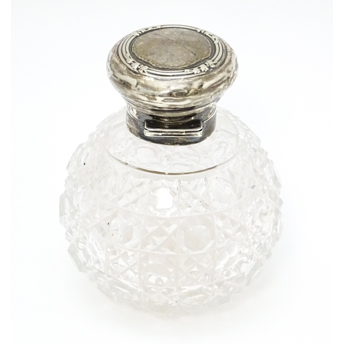 534 - A cut glass dressing table jar with silver lid and mount hallmarked Birmingham 1906. Approx. 4