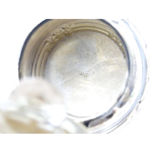 534 - A cut glass dressing table jar with silver lid and mount hallmarked Birmingham 1906. Approx. 4