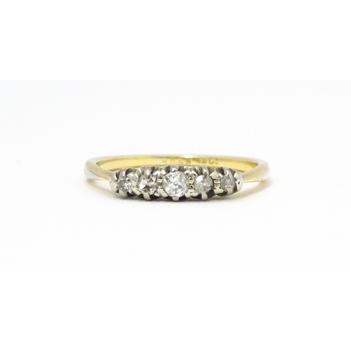 566 - An 18ct gold ring with five diamonds in a linear setting. Ring size approx. O 1/2