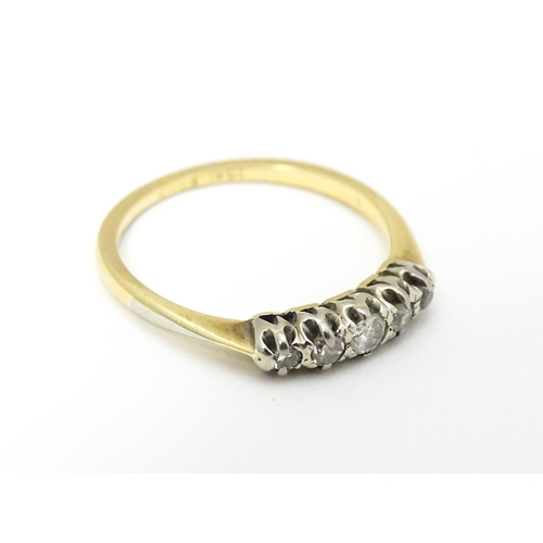 566 - An 18ct gold ring with five diamonds in a linear setting. Ring size approx. O 1/2