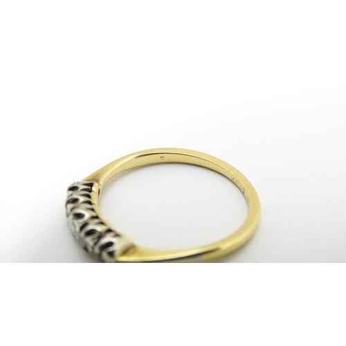 566 - An 18ct gold ring with five diamonds in a linear setting. Ring size approx. O 1/2