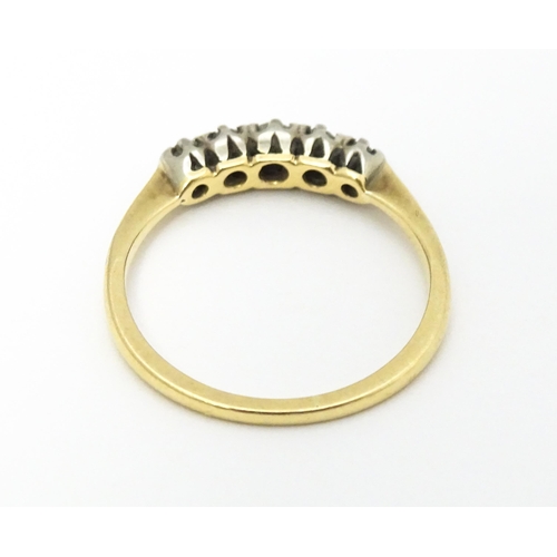 566 - An 18ct gold ring with five diamonds in a linear setting. Ring size approx. O 1/2