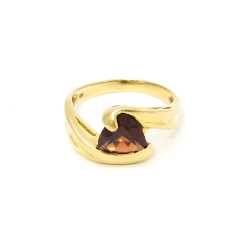 570 - A 9ct gold ring set with garnet in a twist setting. Ring size approx. M 1/2