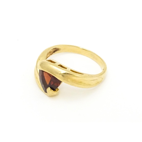 570 - A 9ct gold ring set with garnet in a twist setting. Ring size approx. M 1/2