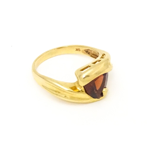 570 - A 9ct gold ring set with garnet in a twist setting. Ring size approx. M 1/2