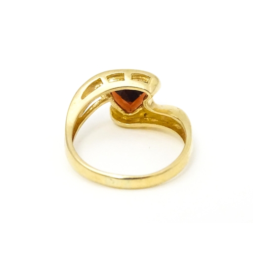 570 - A 9ct gold ring set with garnet in a twist setting. Ring size approx. M 1/2