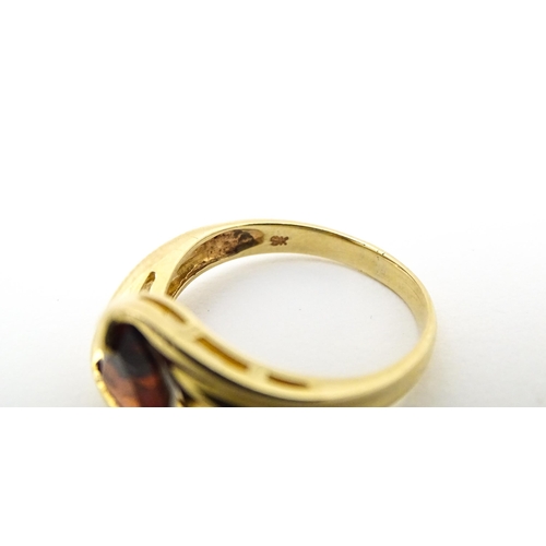 570 - A 9ct gold ring set with garnet in a twist setting. Ring size approx. M 1/2