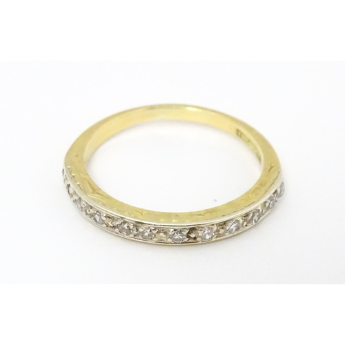 573 - An 18ct gold and platinum half eternity ring set with diamonds. Ring size approx. N 1/2