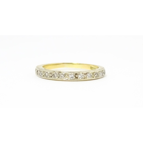 573 - An 18ct gold and platinum half eternity ring set with diamonds. Ring size approx. N 1/2