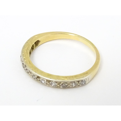 573 - An 18ct gold and platinum half eternity ring set with diamonds. Ring size approx. N 1/2