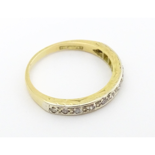 573 - An 18ct gold and platinum half eternity ring set with diamonds. Ring size approx. N 1/2