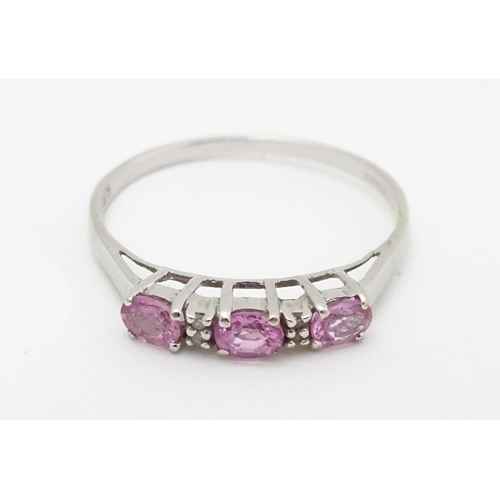 578 - A 9ct white gold ring set with pink sapphires and diamonds. Ring size approx. R