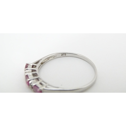 578 - A 9ct white gold ring set with pink sapphires and diamonds. Ring size approx. R