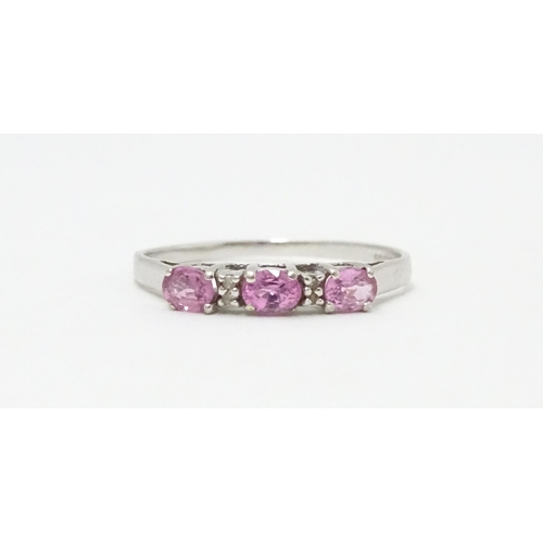 578 - A 9ct white gold ring set with pink sapphires and diamonds. Ring size approx. R