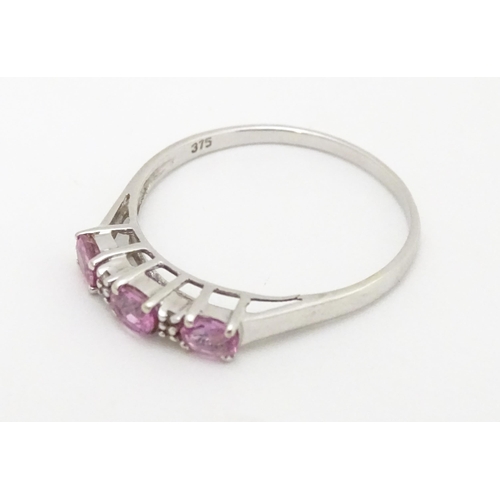 578 - A 9ct white gold ring set with pink sapphires and diamonds. Ring size approx. R