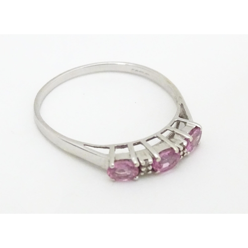 578 - A 9ct white gold ring set with pink sapphires and diamonds. Ring size approx. R