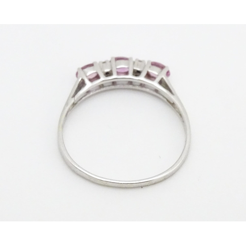 578 - A 9ct white gold ring set with pink sapphires and diamonds. Ring size approx. R