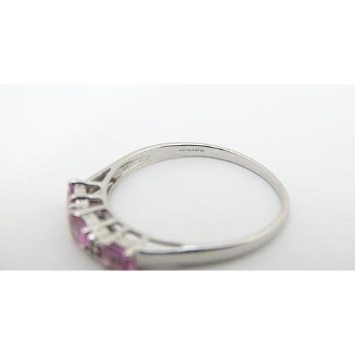 578 - A 9ct white gold ring set with pink sapphires and diamonds. Ring size approx. R