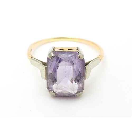 579 - An Art Deco ring set with central amethyst. Ring size approx. P