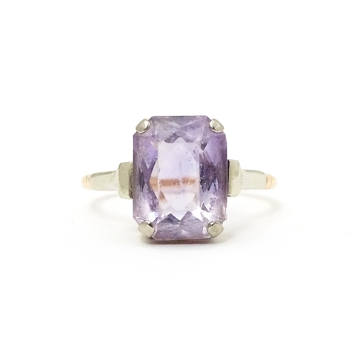 579 - An Art Deco ring set with central amethyst. Ring size approx. P