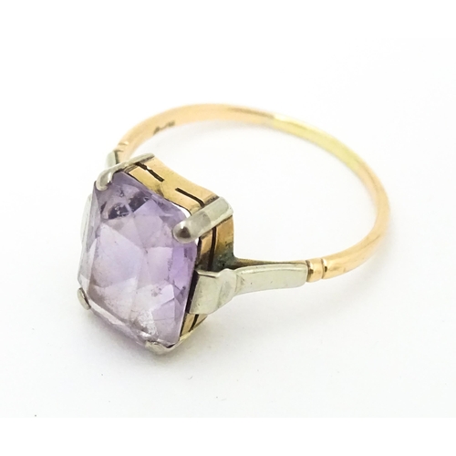 579 - An Art Deco ring set with central amethyst. Ring size approx. P