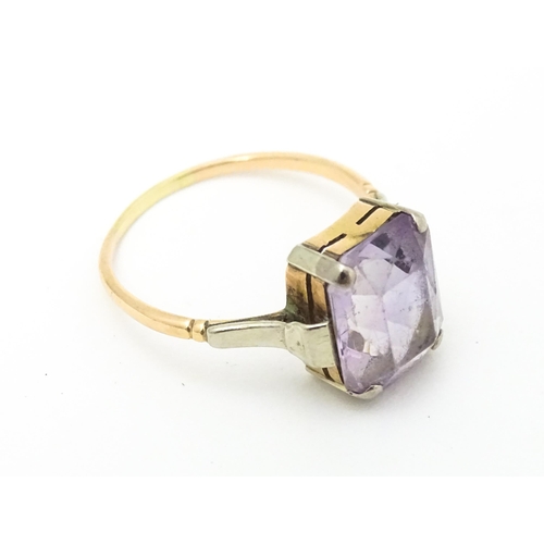 579 - An Art Deco ring set with central amethyst. Ring size approx. P