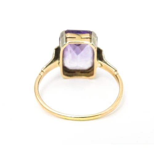 579 - An Art Deco ring set with central amethyst. Ring size approx. P