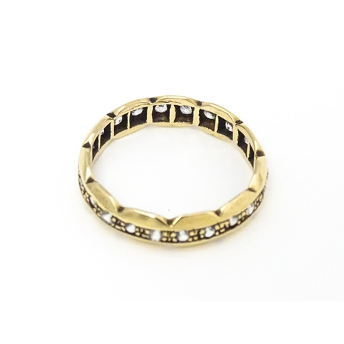 581 - A 9ct gold eternity ring set with white stones. Ring size approx. N.