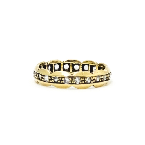 581 - A 9ct gold eternity ring set with white stones. Ring size approx. N.