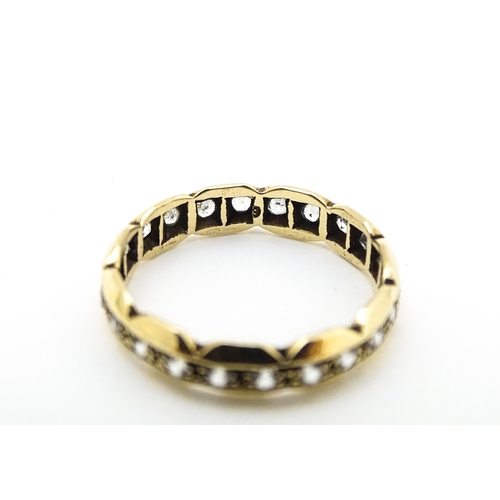 581 - A 9ct gold eternity ring set with white stones. Ring size approx. N.