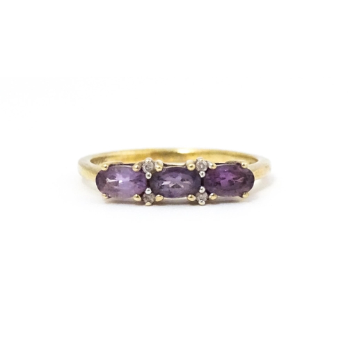 590 - A 9ct gold ring set with amethyst and diamond. Ring size approx. N.