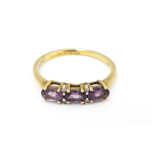 590 - A 9ct gold ring set with amethyst and diamond. Ring size approx. N.