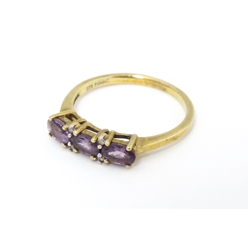 590 - A 9ct gold ring set with amethyst and diamond. Ring size approx. N.