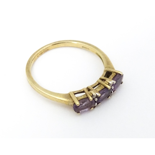 590 - A 9ct gold ring set with amethyst and diamond. Ring size approx. N.