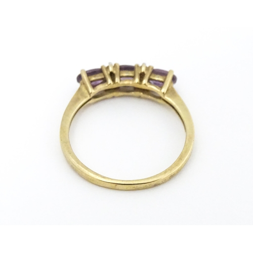 590 - A 9ct gold ring set with amethyst and diamond. Ring size approx. N.