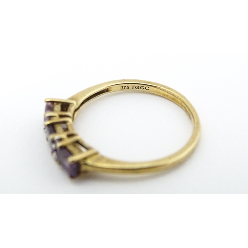 590 - A 9ct gold ring set with amethyst and diamond. Ring size approx. N.