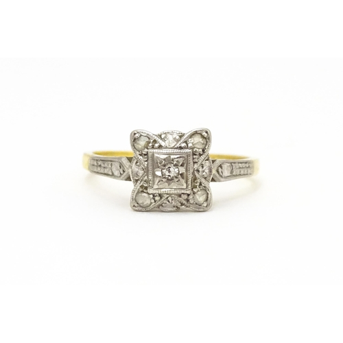 596 - An 18ct gold ring with platinum set diamonds. Ring size approx. M