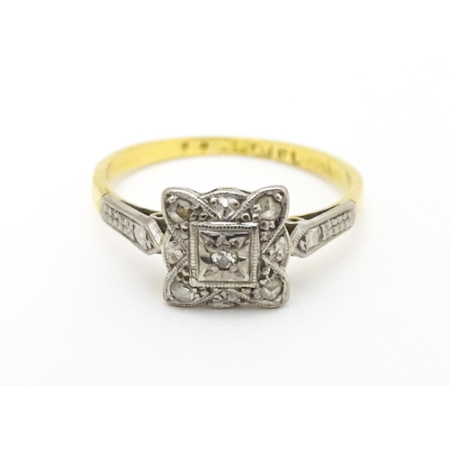 596 - An 18ct gold ring with platinum set diamonds. Ring size approx. M