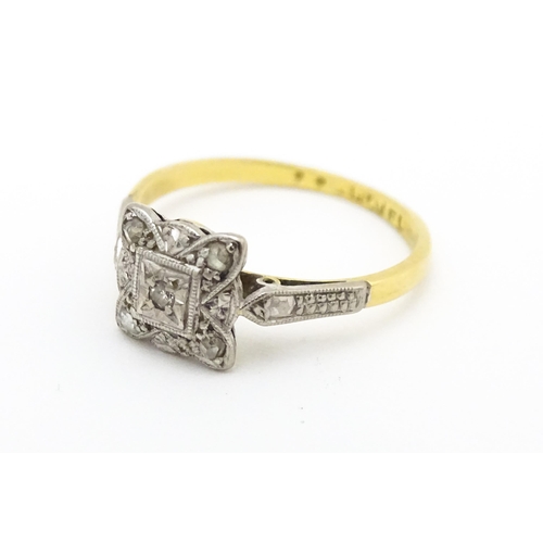 596 - An 18ct gold ring with platinum set diamonds. Ring size approx. M